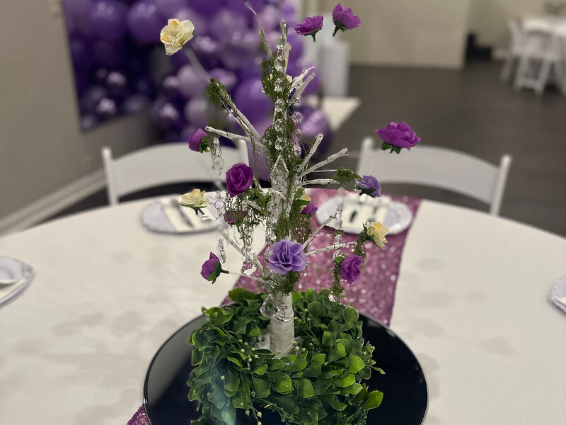 Purple rose and crystal branch centerpiece on a sequin table runner for a milestone birthday at The Cove at St. Johns, St. Johns County FL