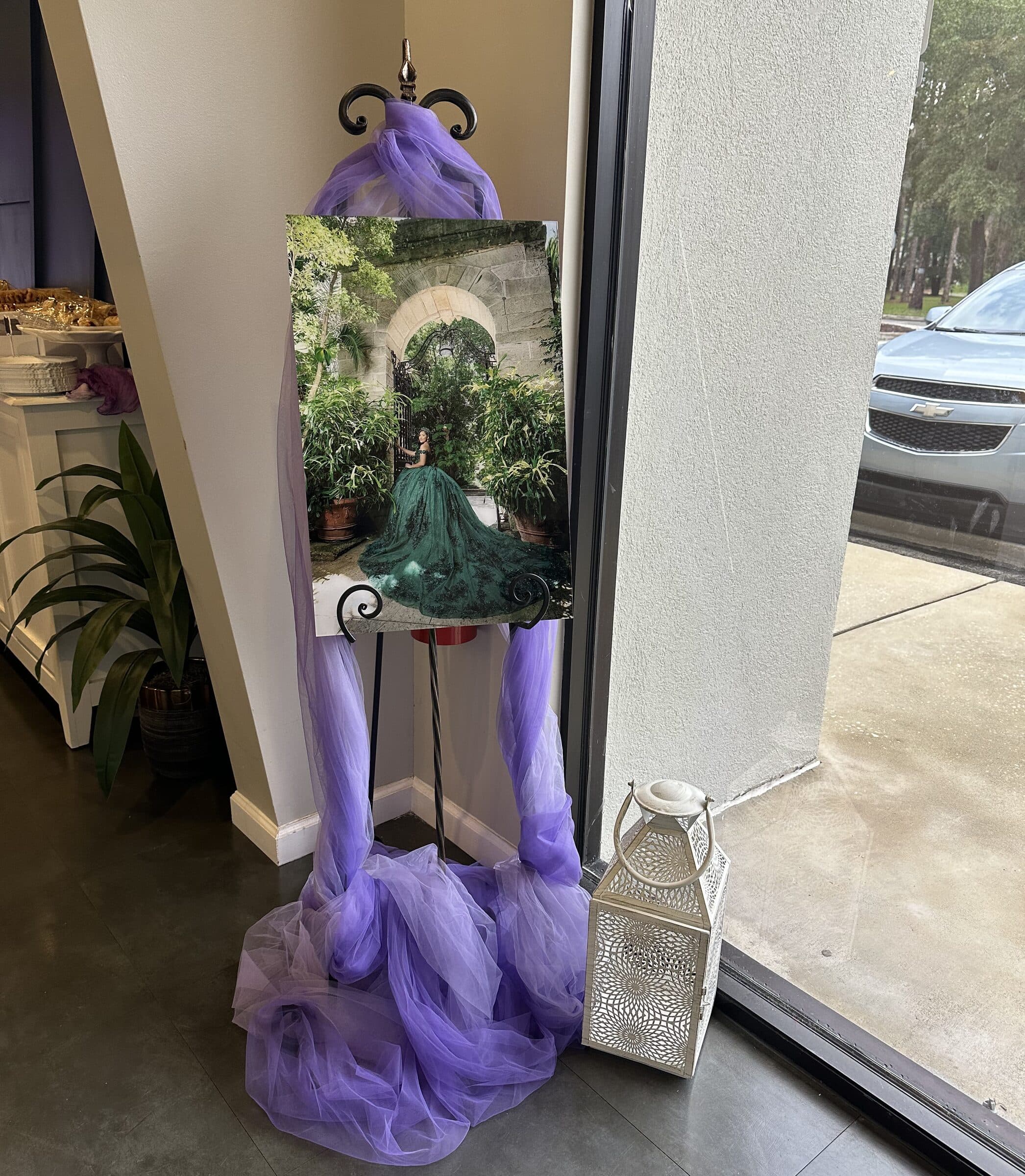 Framed portrait of the guest of honor on an easel wrapped in purple tulle at a quinceanera at The Cove at St. Johns, Fruit Cove, St. Johns County FL