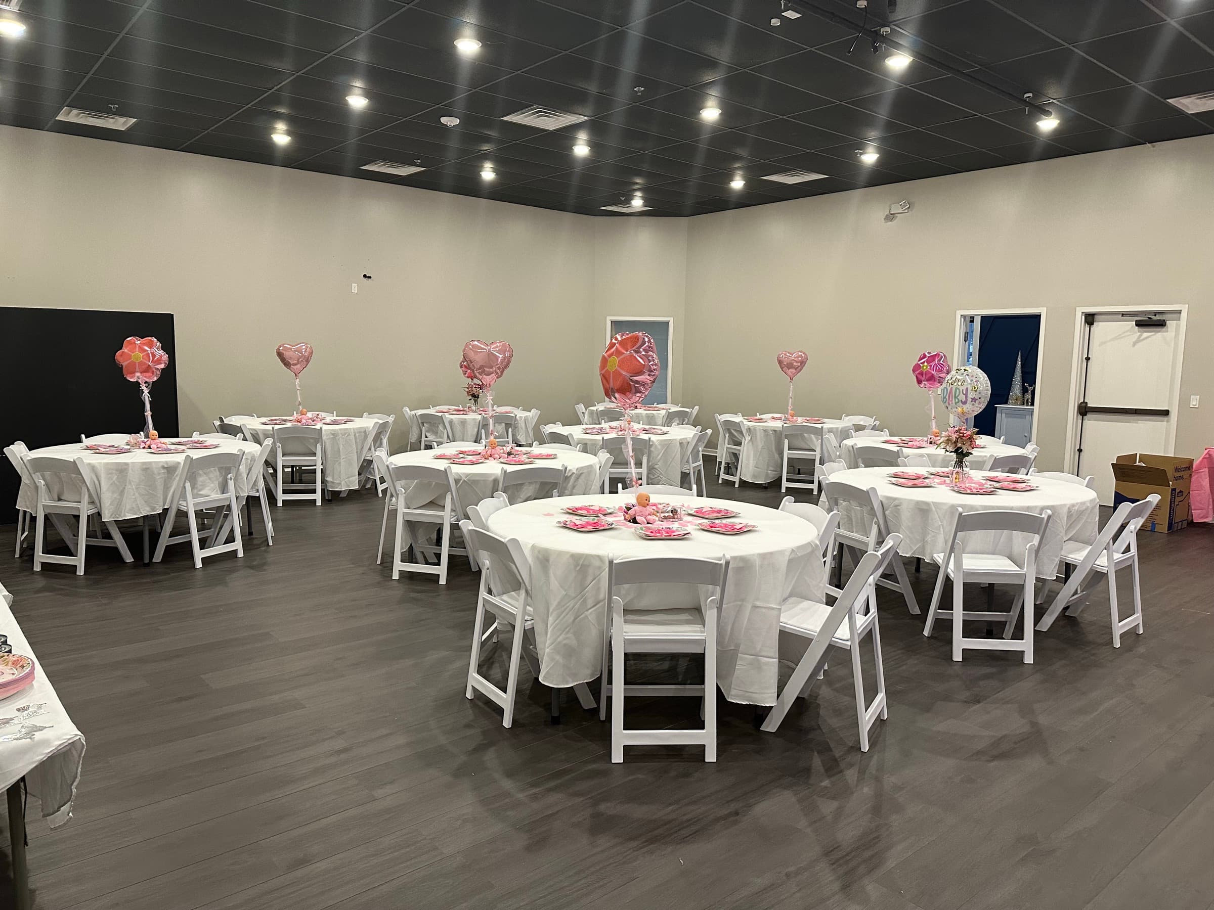 Baby shower with pink balloon centerpieces on white-draped round tables at The Cove at St. Johns, Fruit Cove FL
