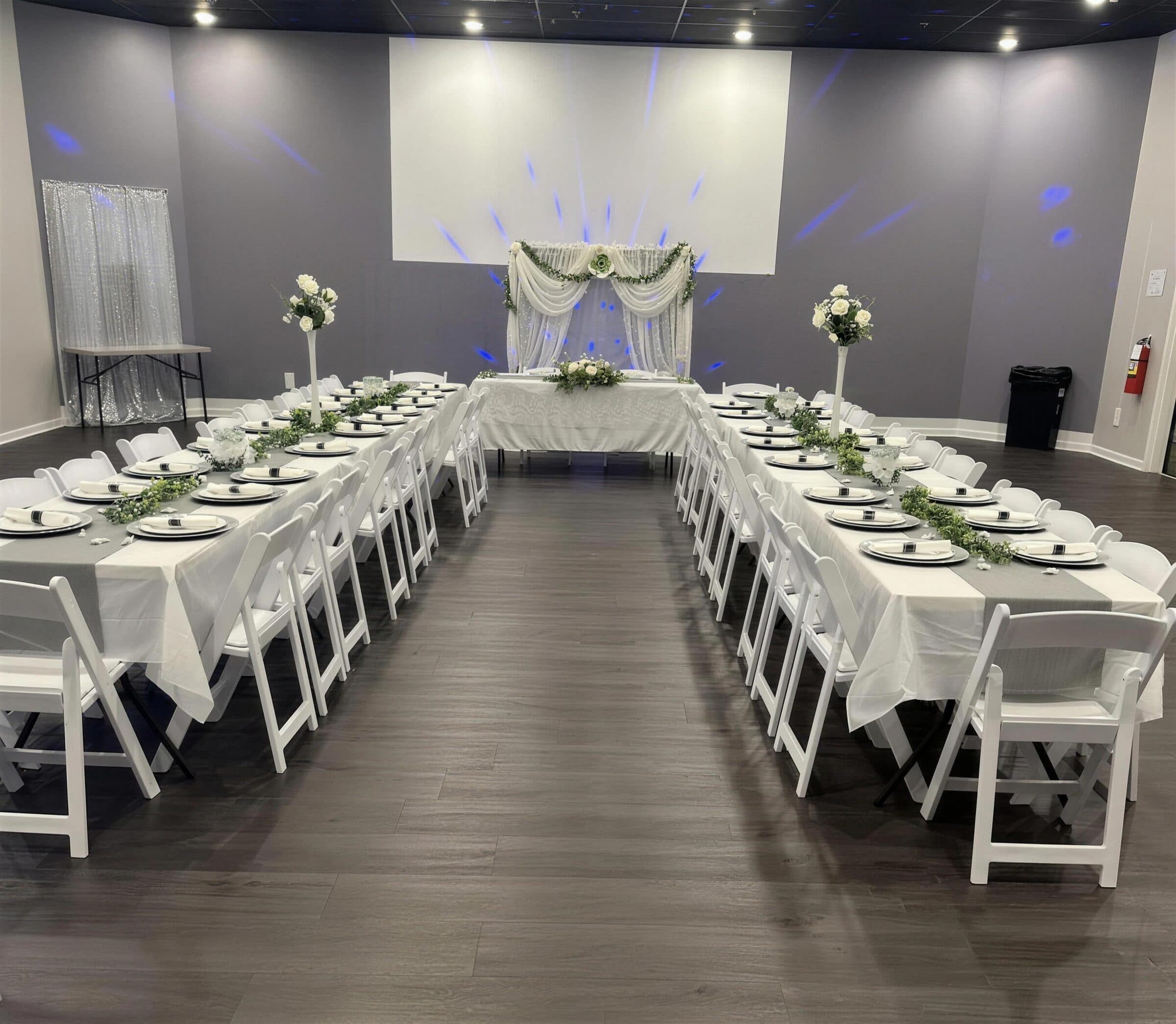 Long banquet tables set in a U at The Cove at St. Johns, Fruit Cove, FL — the layout for a weekly class or workshop.
